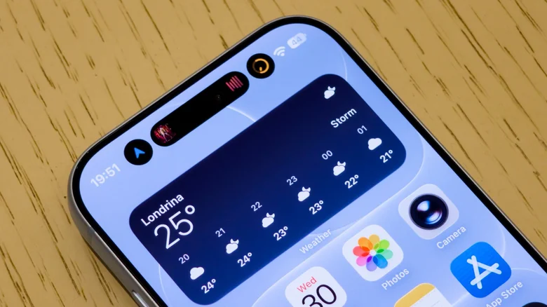 Dynamic Island on the iPhone 18 Pro showing three different Live Activities.