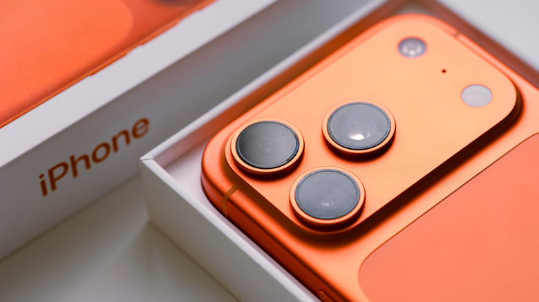 Orange iPhone 17 Pro in its opened box.
