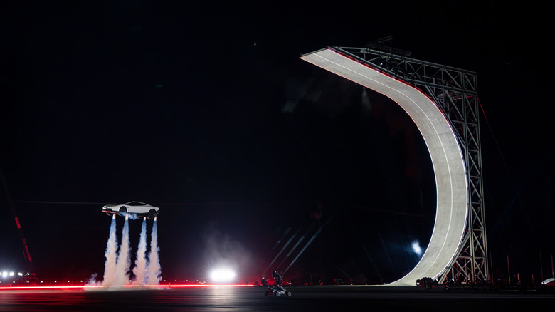 The Tesla Roadster floating to the ground after completing a flip.