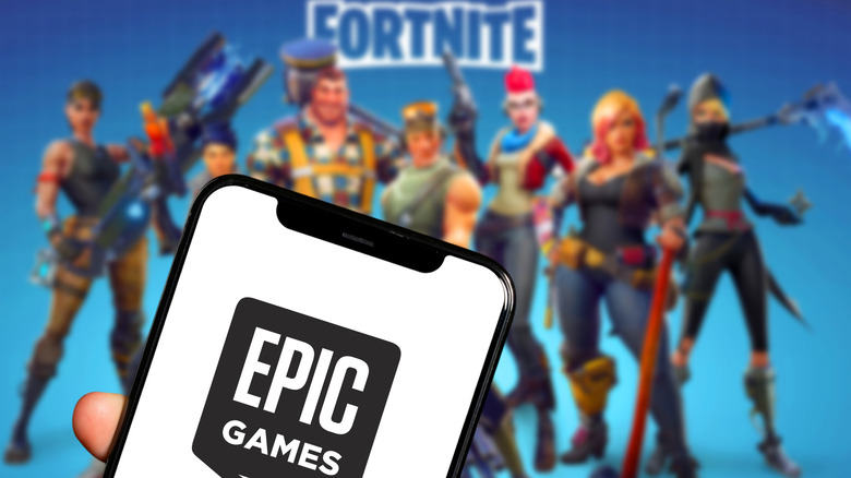Epic games logo shown in front of Fortnite characters and logo
