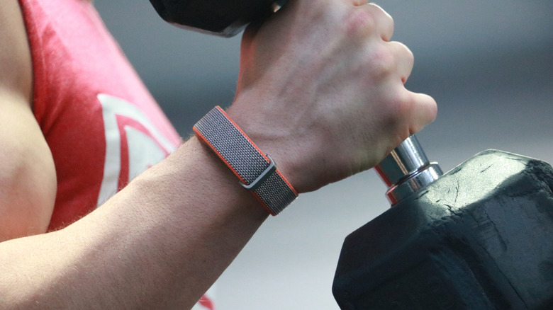 An arm doing a bicep curl with a Fitbit Air on