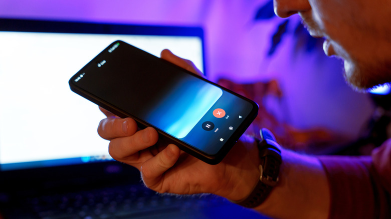 Person holding a phone with Gemini Live on the screen.