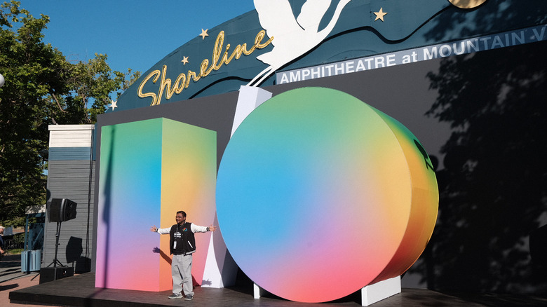 A person standing in front of the I/O logo at Shoreline Amphitheatre.