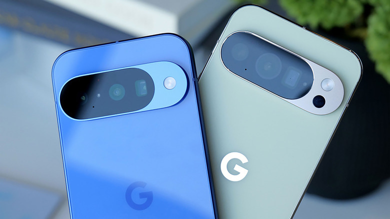 The tops of two Google Pixel 10 phones (backsides) arranged in a V-shape