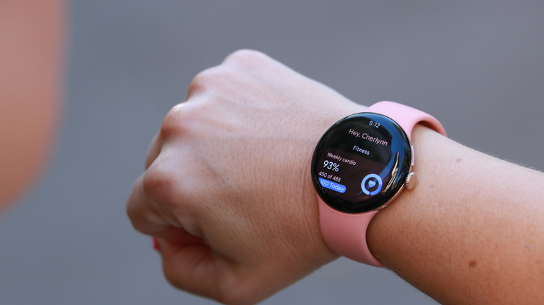 A person holding up their wrist with the Pixel Watch 5 on it, showing the Fitness page.