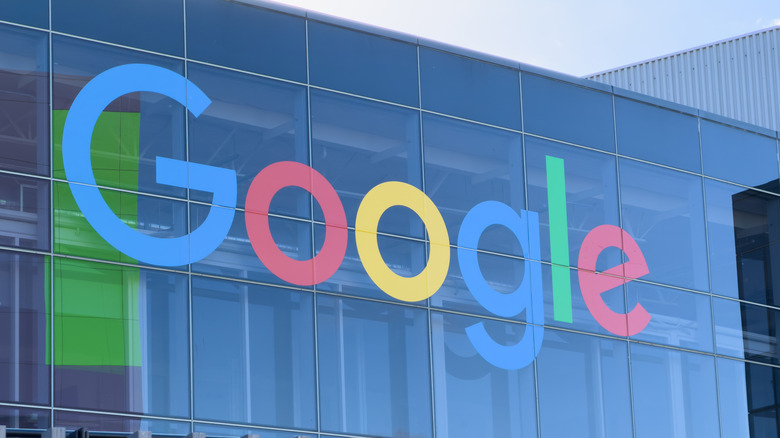 Photo of the Google logo on the exterior of a glass building.