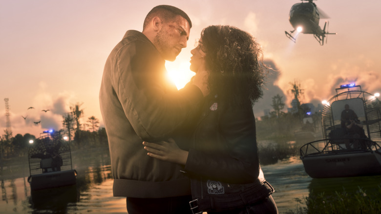 Jason and Lucia embracing in front of police boats and helicopters in GTA VI.