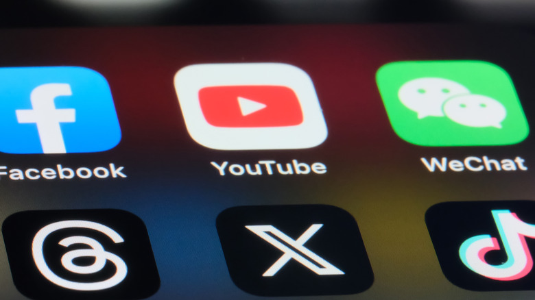 Icons for Facebook, TikTok and other social media platforms are shown on a smartphone.