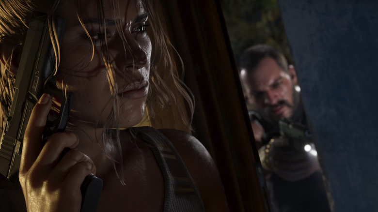 Lucia hides from an approaching attacker with her gun raised in GTA VI.