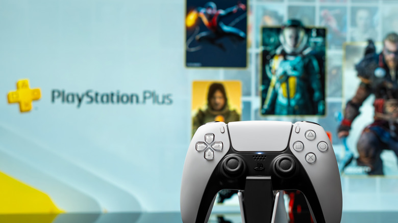 A DualSense set in front of screen with the PlayStation Plus menu.