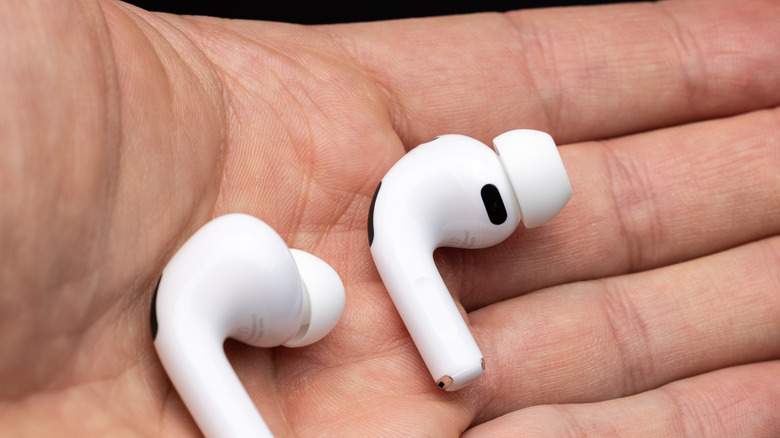 Two AirPods Pro buds in a hand.