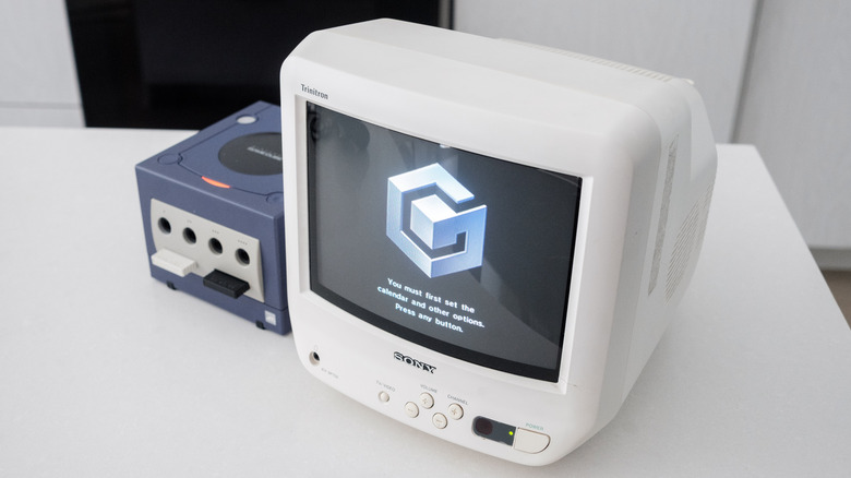 A white Sony CRT displays the GameCube's startup screen.