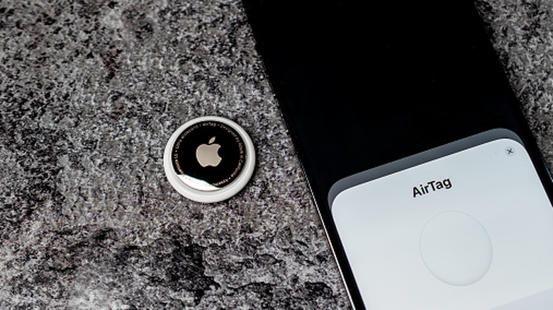 Pairing an AirTag with an iPhone over NFC.