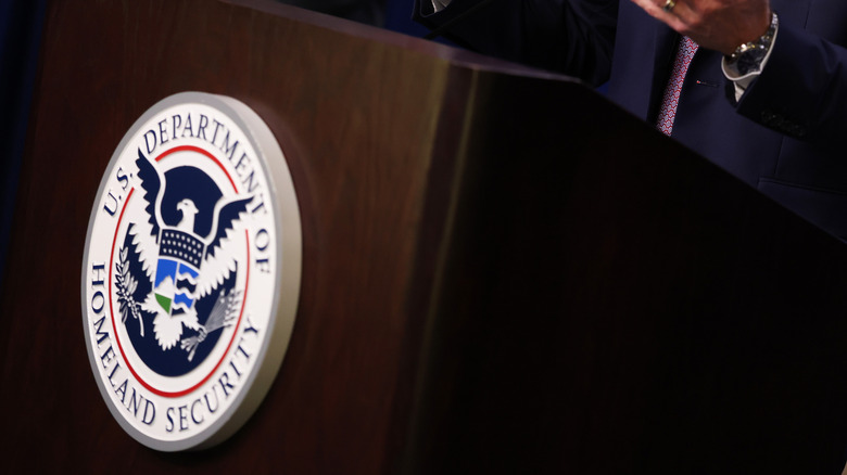 The US Department of Homeland Security logo on a podium.