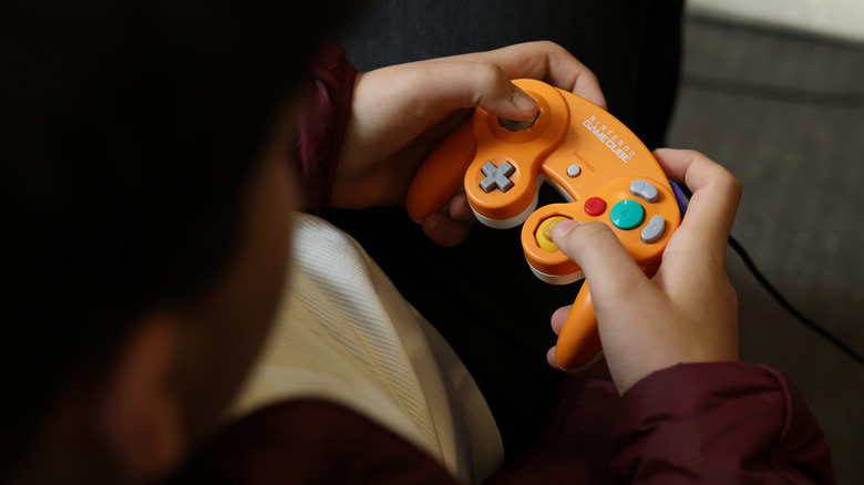 Image of person using GameCube controller.