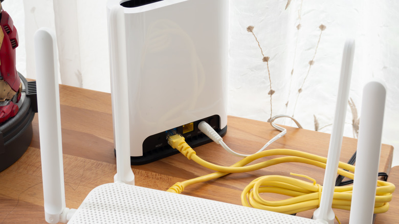 A router connected to a modem through an Ethernet cable.