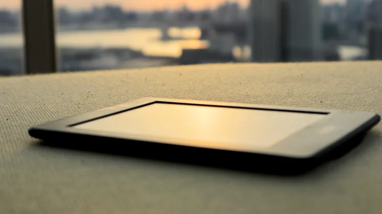 A Kindle sitting on a table.