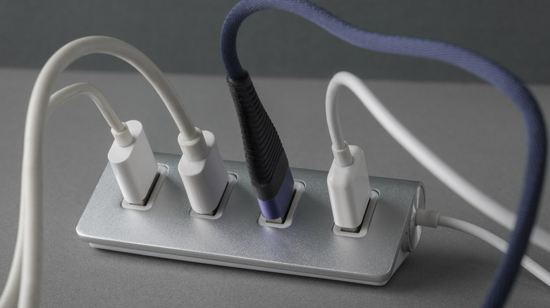 Multiple USB cables plugged into USB hub.