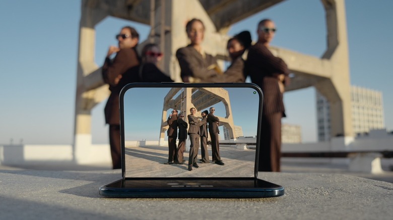 iPhone Duo automatically taking photos as a group of people pose for the camera.
