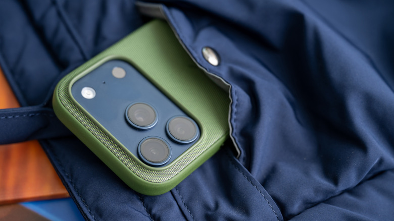 iPhone camera lenses showing from a phone in a pocket