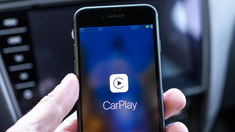 Apple iPhone screen with CarPlay logo in the center.