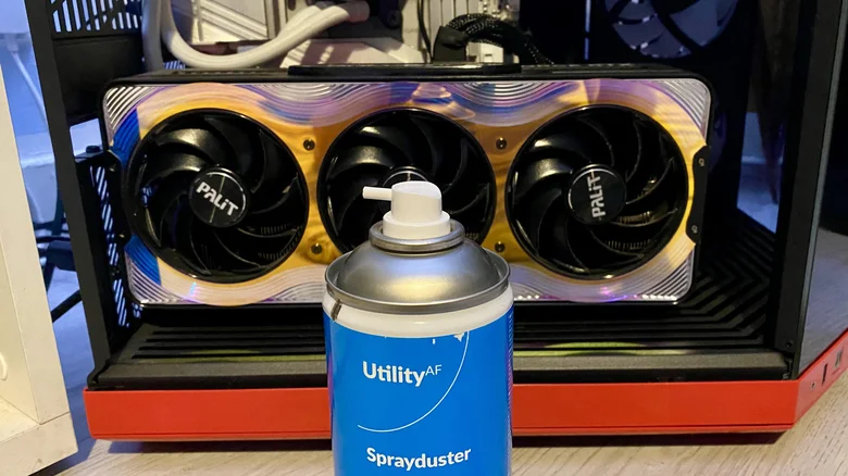 A can of compressed air next to an NVIDIA RTX 5090 GPU.