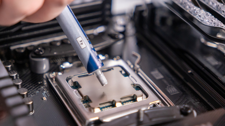 Image of someone applying thermal paste to the CPU.