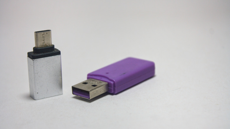 Two USB-A to C adapters, one in silver and one in purple.
