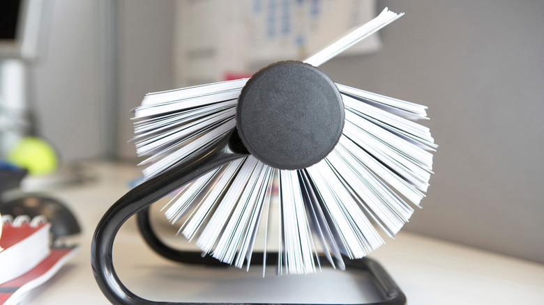 Side view of a Rolodex sitting on a desk.