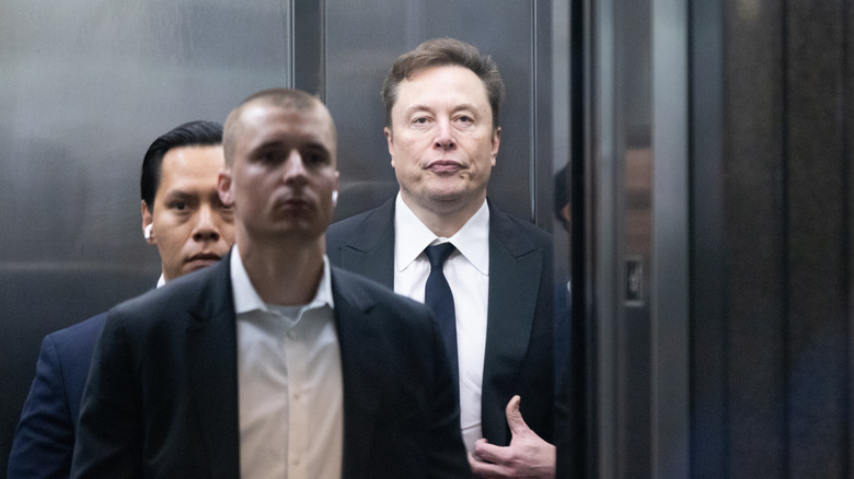 Elon Musk is pictured as he enters an elevator.