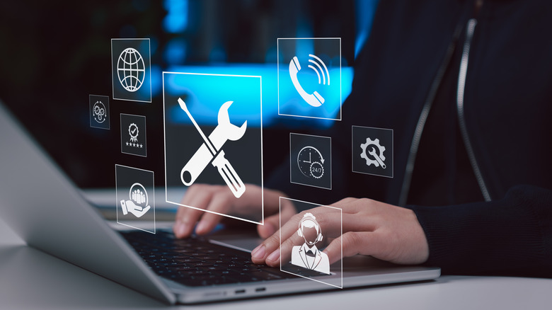Person using a laptop with technical support and repair icons overlaid on the screen.