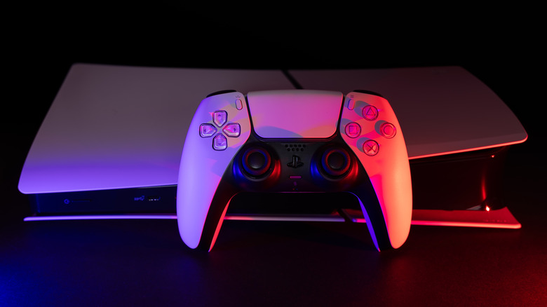 A Sony PlayStation 5 with a DualSense controller against a black background.