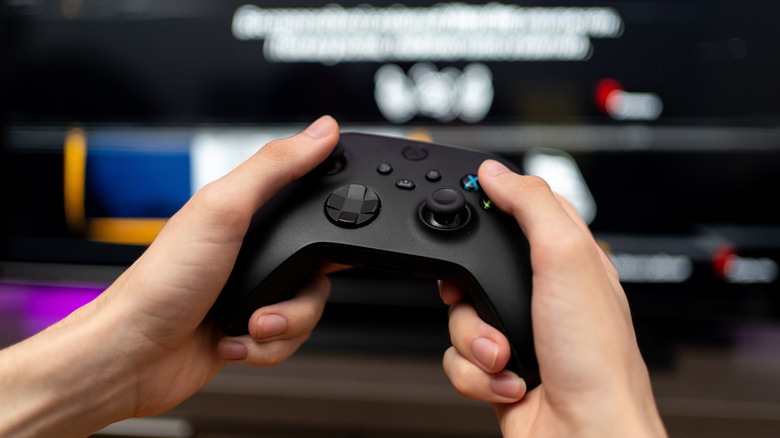 A person holding an Xbox Wireless Controller