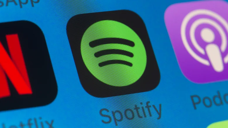 The Spotify app icon on an iPhone screen.