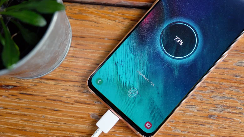Phone on desk getting charged.
