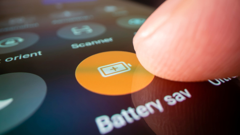 Finger touching the Battery saving feature on Android phone.