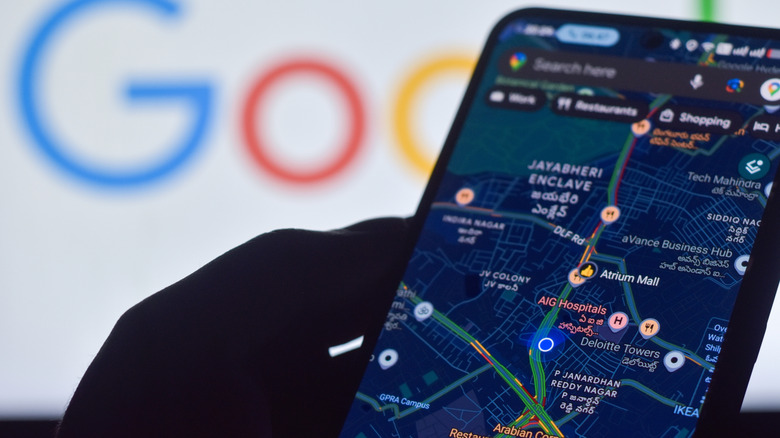 An Android phone showing a map with a Google logo in the background.