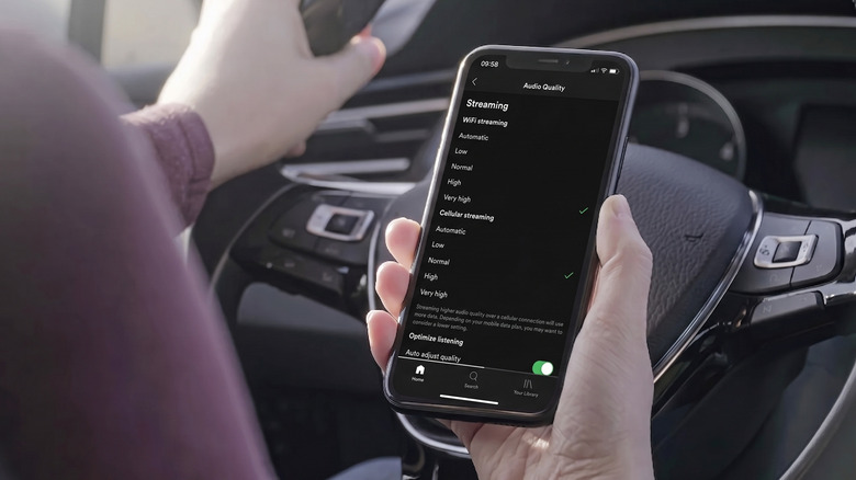 Person adjusting the Audio Quality setting in the Spotify app on iPhone.