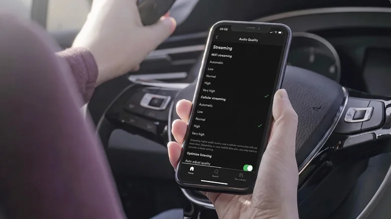 Person adjusting the Audio Quality setting in the Spotify app on iPhone.