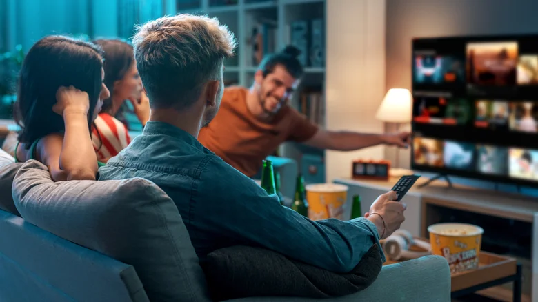 Group of people watching Netflix on TV.