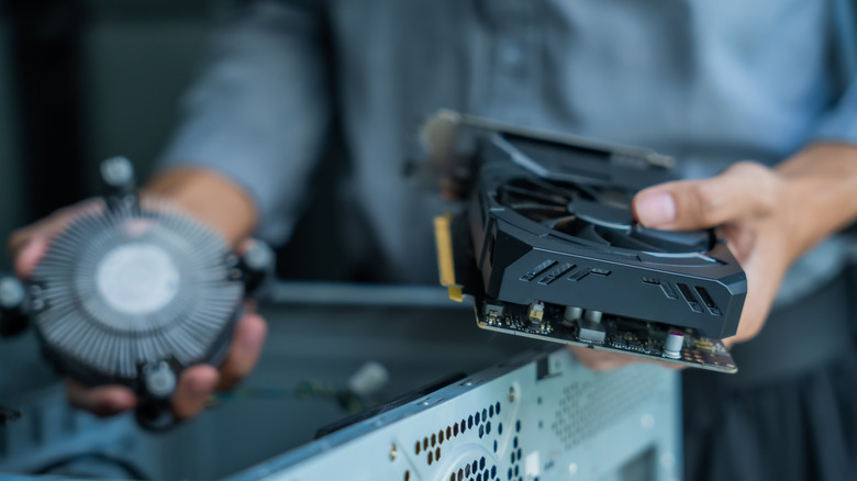 Person holding fans to put into a PC case.
