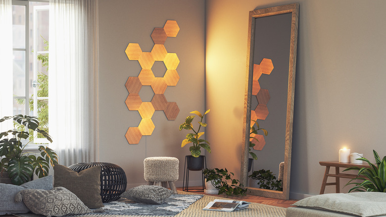 Nanoleaf Elements panels lighting up the corner of a living room.