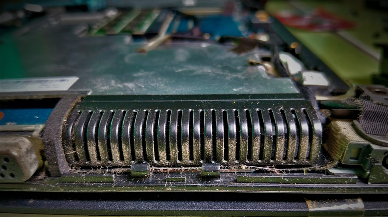 Dust built up on the heat-sink fins inside a laptop.