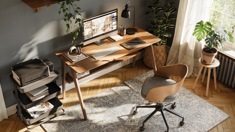 Home office with monitor, keyboard, and other gadgets