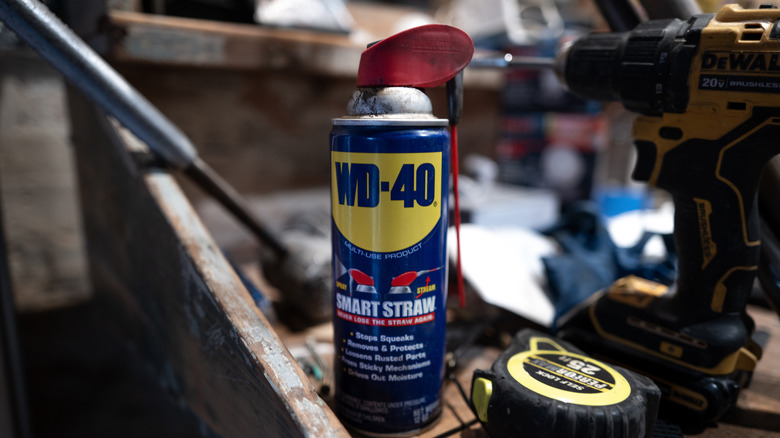 A can of WD-40 sitting on a workbench