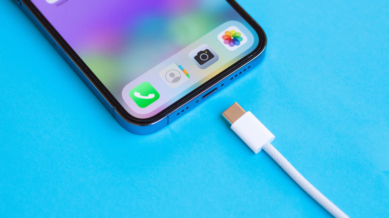 Close-up of an Apple USB-C cable being plugged into an iPhone.