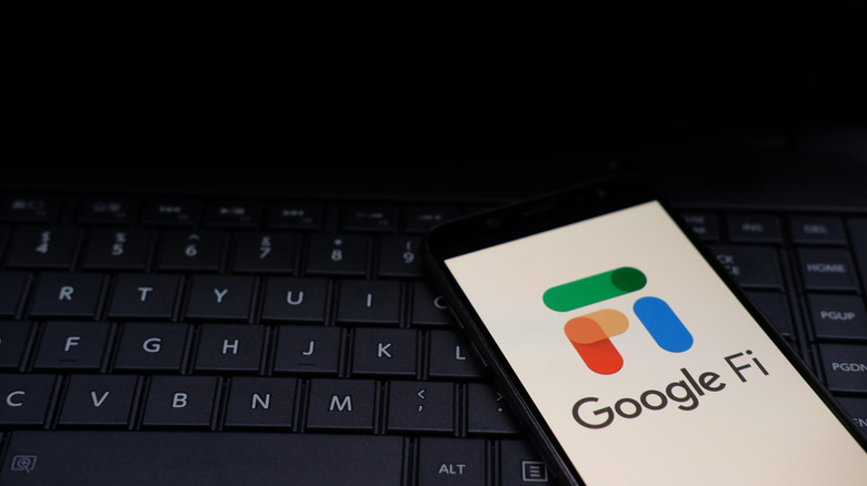 The Google Fi logo on a smartphone, resting on a keyboard.