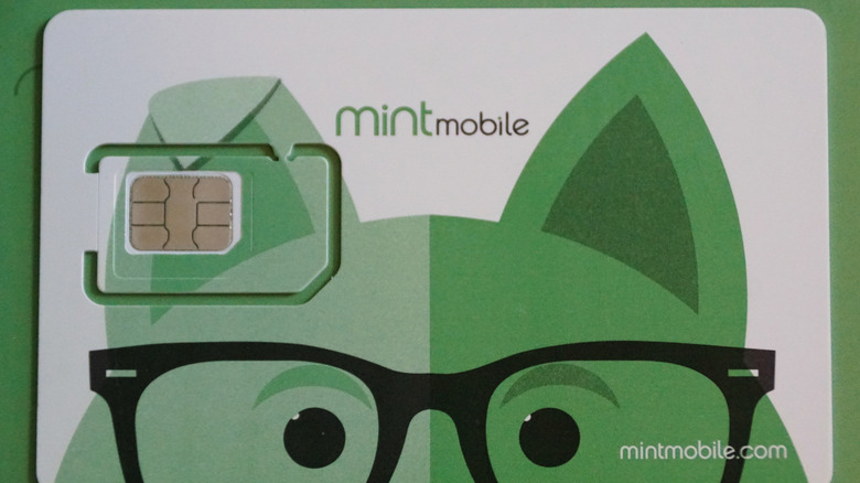 A Mint Mobile SIM card on a green background.