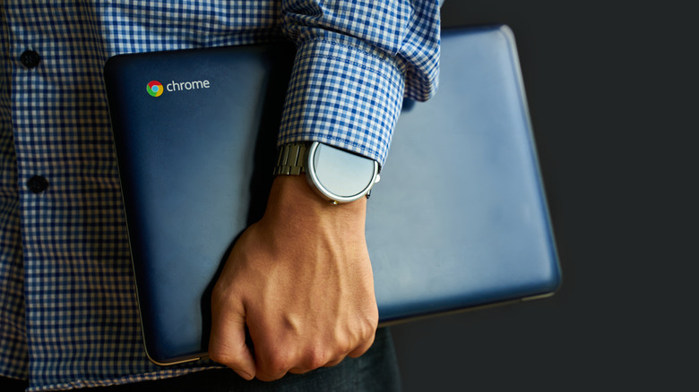 Man holding a Chromebook.