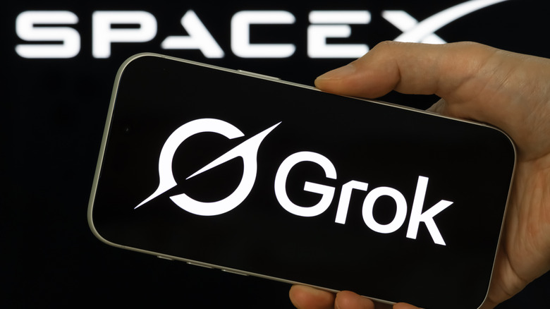 Grok Logo on a smartphone held in front of SpaceX logo